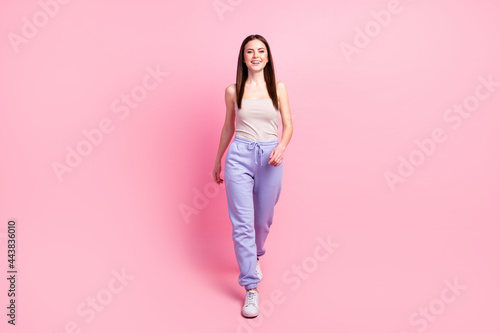Full body photo of young attractive girl happy positive smile go walk step isolated over pastel color background