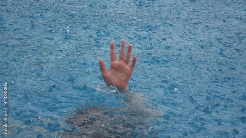 girl's hand drowning in the rain  photo