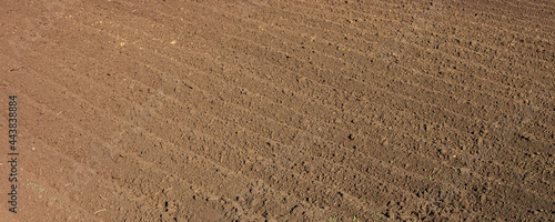 Deep furrows in the field after plowing, wide view
