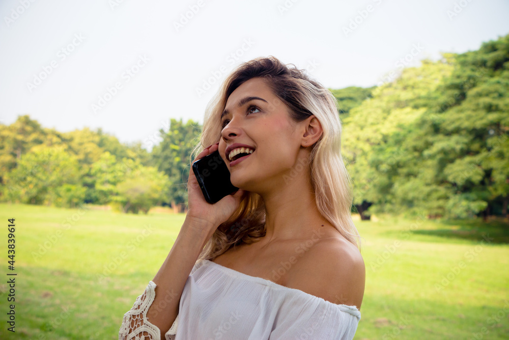 Portrait of a smiling beautiful woman texting and talking with her phone Portrait of a smiling beautiful woman texting and talking with her phone