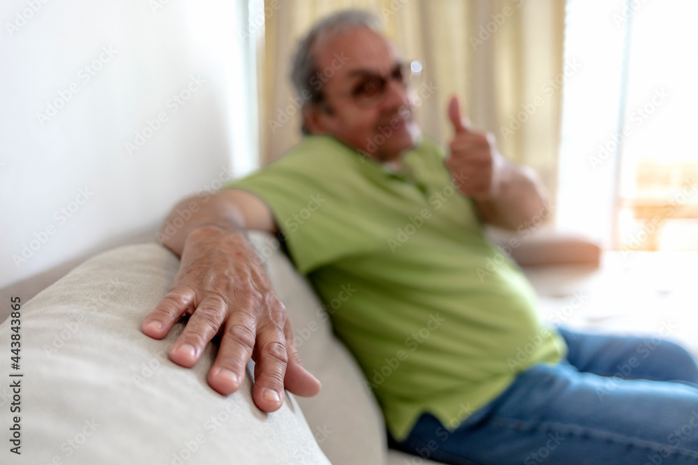 Portrait of happy senior man smiling at home. Old man relaxing on sofa and looking at camera. Portrait of elderly man enjoying retirement. Portrait of a kind senior man. Portrait of happy senior man smiling at home. Old man relaxing on sofa and looking at camera. Portrait of elderly man enjoying retirement. Portrait of a kind senior man.