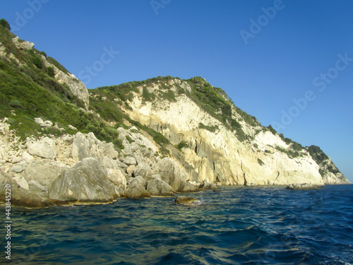 Rocky sea coast, overgrown with green bushes