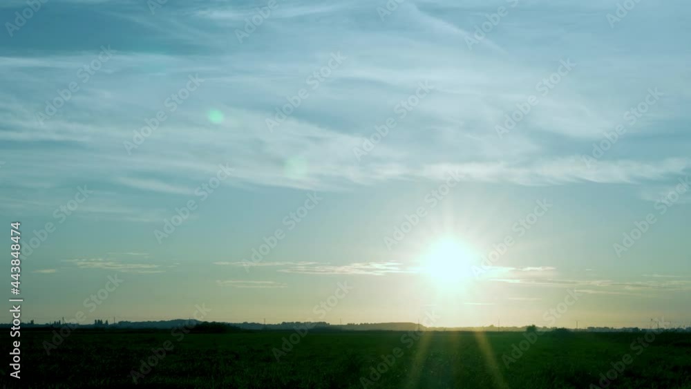 The Sun is the Sky and Cirrus Clouds at Sunset in the Field, Time Lapse. Background of the Sun, Blue Sky and Light Clouds in the Field. Nature 4K. Beautiful Landscape. The Sun is the Sky and Cirrus Clouds at Sunset in the Field, Time Lapse. Background of the Sun, Blue Sky and Light Clouds in the Field. Nature 4K. Beautiful Landscape.