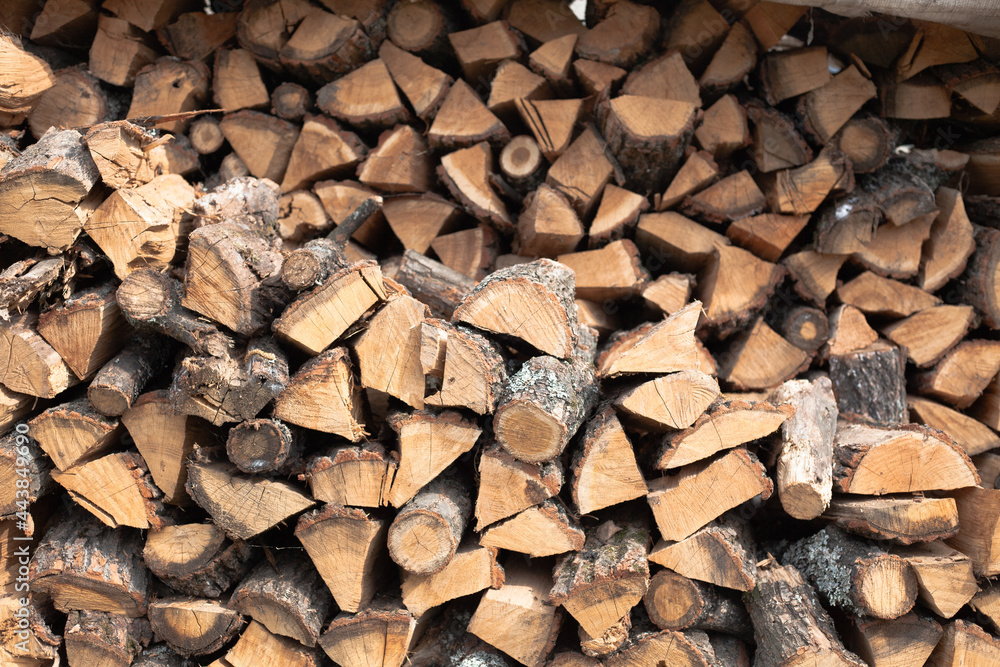 Stacked firewood background. Firewood pattern. Wood saving wall. Natural materials background. Stock of wood for kindling a fireplace for the winter. Stacked firewood background. Firewood pattern. Wood saving wall. Natural materials background. Stock of wood for kindling a fireplace for the winter.