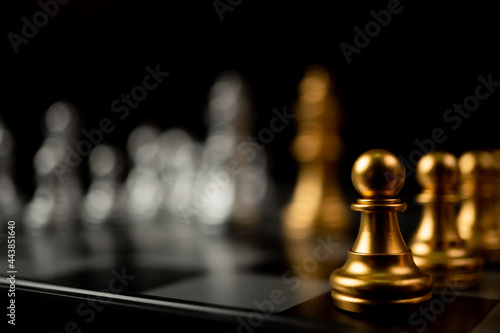 Golden Chess pawn standing in front of other chess, Concept of a leader must have courage and challenge in the competition, leadership and business vision for a win in business games