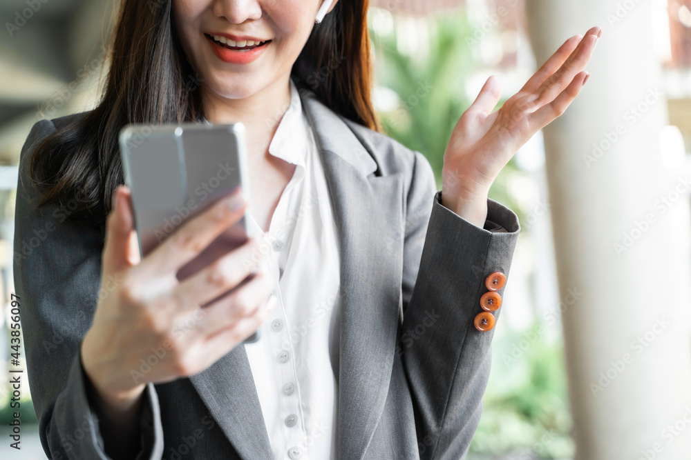 Happy Confident young asian businesswoman use the smartphone. business successful technology