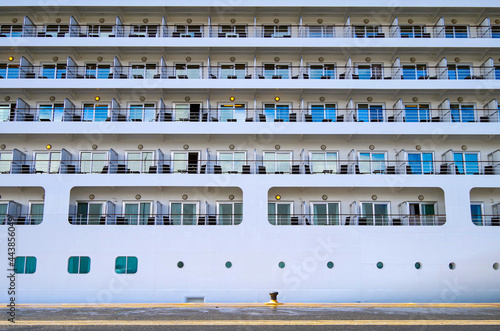 Cruiseship cruise ship liner in port with detail view of portside fuselage of Silversea Silver Spirit with porthole windows and balconies photo