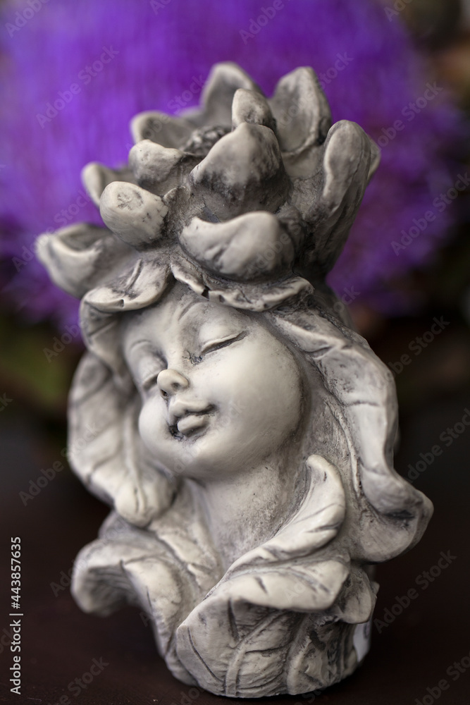 Little figurine of a fairy girl for outdoor garden decoration