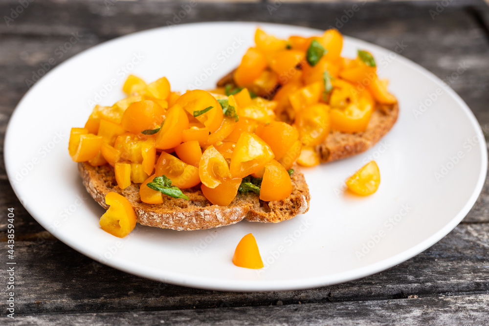 Friselle with yellow tomatoes. Italian fresh appetizer. Friselle with yellow tomatoes. Italian fresh appetizer.