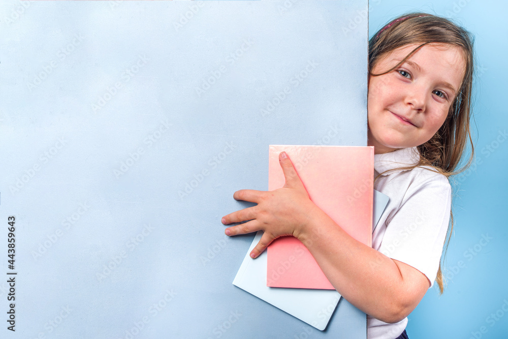 Back to school concept. School invitation, advertisement banner. Cute primary school student girl in white blue classic uniform, with books, notepads. Colorful bright blue background copy space Back to school concept. School invitation, advertisement banner. Cute primary school student girl in white blue classic uniform, with books, notepads. Colorful bright blue background copy space