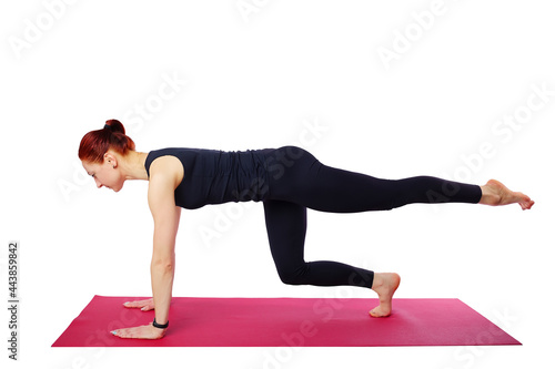 Pilates or yoga. This slender beautiful woman performs a Pilates exercise on a gym mat. Isolated on a white background. Visual aid