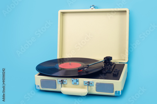 Vintage vinyl record player isolated on blue background