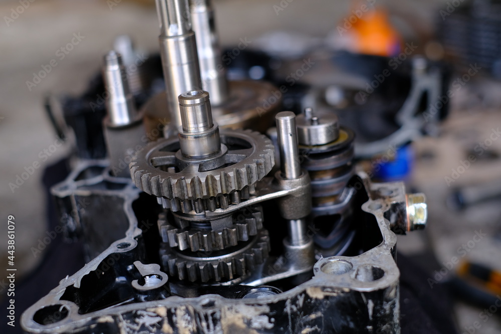 A motorcycle mechanic is working on the engine gear. A motorcycle mechanic is working on the engine gear.