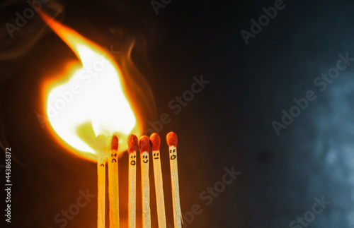 Group of a red match burning isolated with the background. Row burning matchstick in the chain reaction. Matchstick art photography.