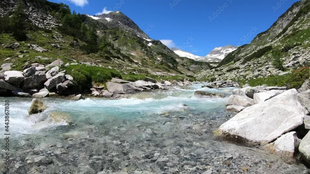 A rushing torrent in Maltatal, Carinthia, Austria. There are high snow-capped Alpine peaks in the back. The slopes of the mountains are very steep. Green pastures. Idyllic landscape.
A rushing torrent in Maltatal, Carinthia, Austria. There are high snow-capped Alpine peaks in the back. The slopes of the mountains are very steep. Green pastures. Idyllic landscape.