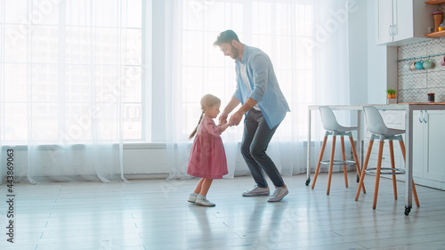 Dancing young father and little preschool girl