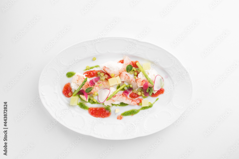 Avocado and Shrimps Salad on white plate isolated on white background Avocado and Shrimps Salad on white plate isolated on white background