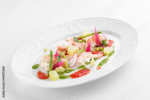 Avocado and Shrimps Salad on white plate isolated on white background