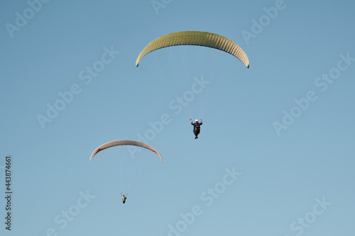 Paragliders against the blue sky. Air sports.. Active rest outside the city