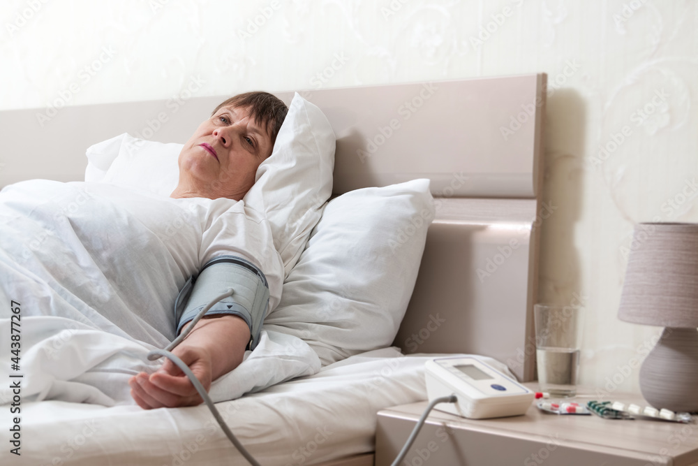 Providing first aid to an elderly woman. Measurement of blood pressure with a tonometer. Grandma got a little sick. Providing first aid to an elderly woman. Measurement of blood pressure with a tonometer. Grandma got a little sick.