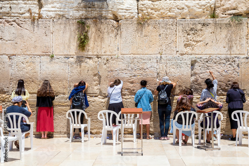 women near Wailing Wall or Western Wall, in Islam as Buraq Wall was built from ancient limestone. It is relatively small segment of far longer ancient retaining
