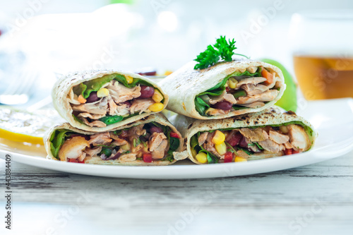 Traditional Mexican Food -  Burrito, on white wooden retro table