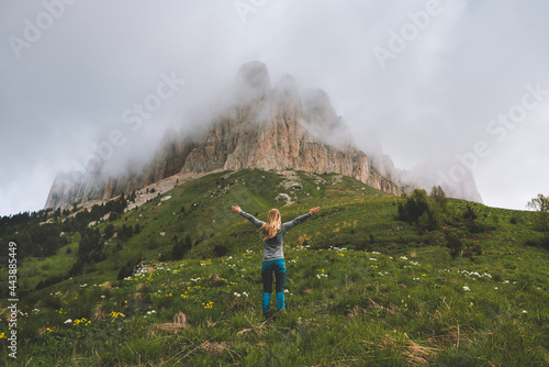 Fototapeta Naklejka Na Ścianę i Meble -  Hiking adventures in foggy mountains woman hiker raised hands travel solo extreme vacations outdoor healthy lifestyle active trip