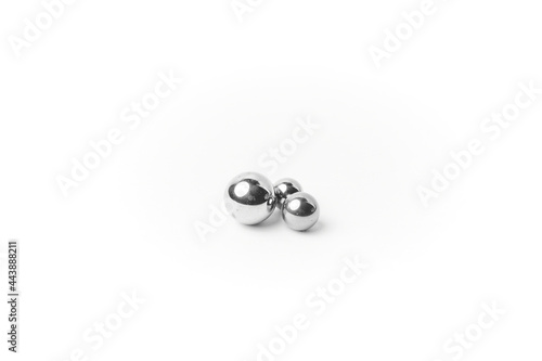 Close up of metallic spheres isolated on white, chrome polished balls