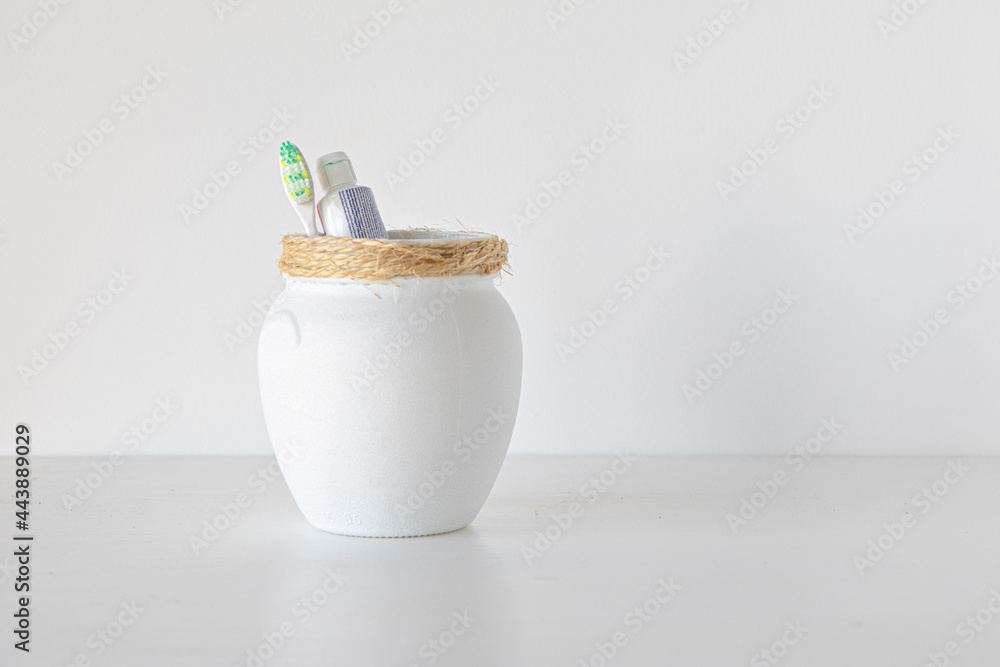 White jars on white background minimalism concept White jars on white background minimalism concept