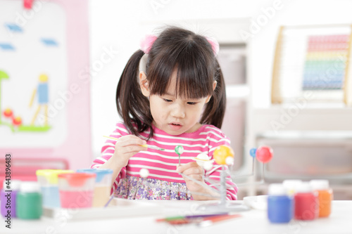 young girl making craft for homeschooling