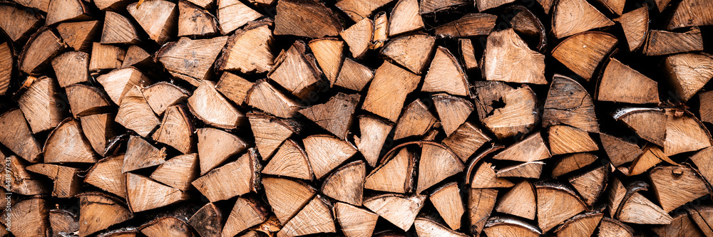textured firewood background of chopped wood for kindling and heating the house. a woodpile with stacked firewood. the texture of the birch tree. banner textured firewood background of chopped wood for kindling and heating the house. a woodpile with stacked firewood. the texture of the birch tree. banner