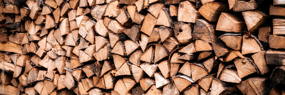 textured firewood background of chopped wood for kindling and heating the house. a woodpile with stacked firewood. the texture of the birch tree. banner textured firewood background of chopped wood for kindling and heating the house. a woodpile with stacked firewood. the texture of the birch tree. banner