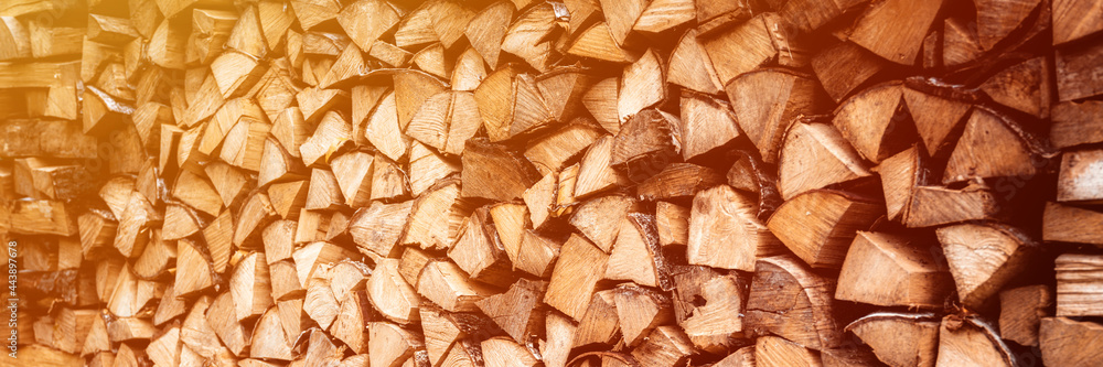 textured firewood background of chopped wood for kindling and heating the house. a woodpile with stacked firewood. the texture of the birch tree. banner. flare textured firewood background of chopped wood for kindling and heating the house. a woodpile with stacked firewood. the texture of the birch tree. banner. flare