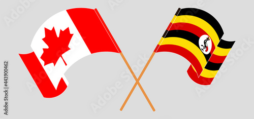 Crossed and waving flags of Canada and Uganda