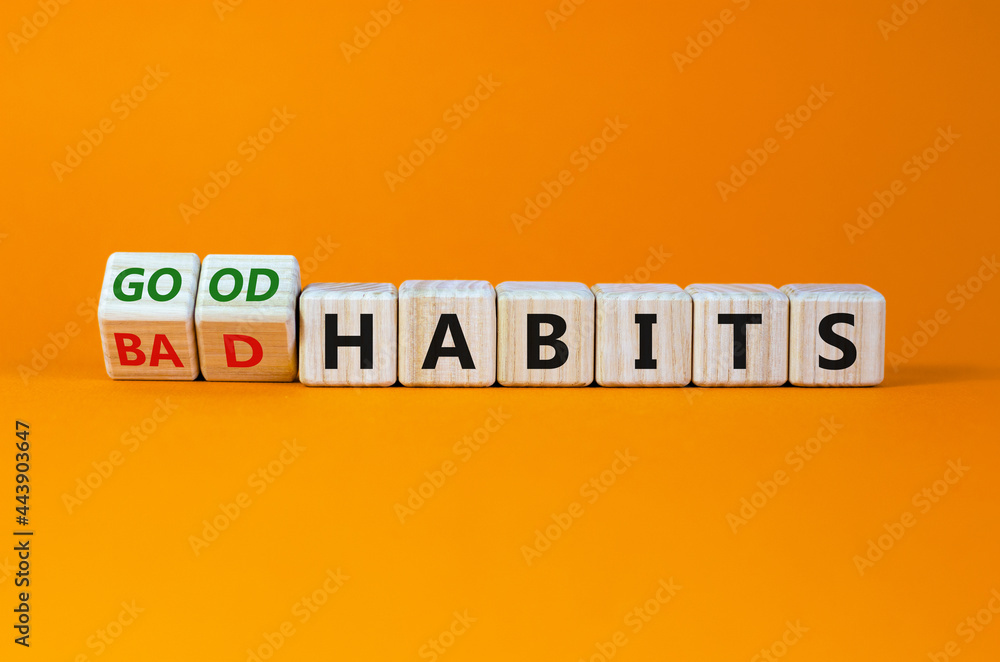 Good or bad habits symbol. Turned wooden cubes, changed words 'bad habits' to 'good habits'. Beautiful orange table, orange background. Business, bad or good habits concept. Copy space. Good or bad habits symbol. Turned wooden cubes, changed words 'bad habits' to 'good habits'. Beautiful orange table, orange background. Business, bad or good habits concept. Copy space.