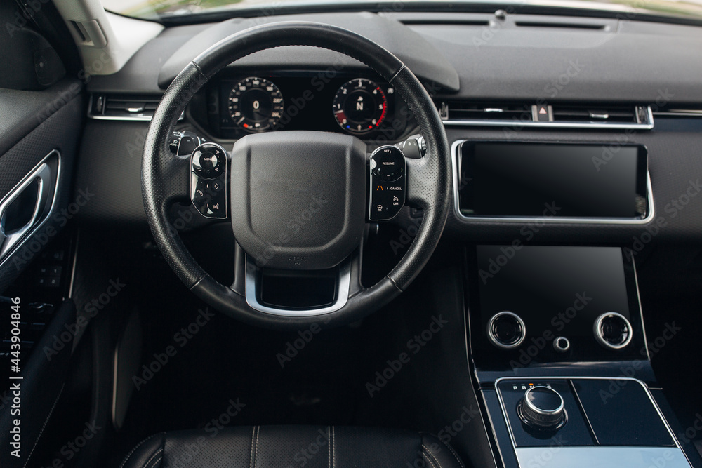 Expensive car interior with the steering wheel and multimedia dashboard Expensive car interior with the steering wheel and multimedia dashboard