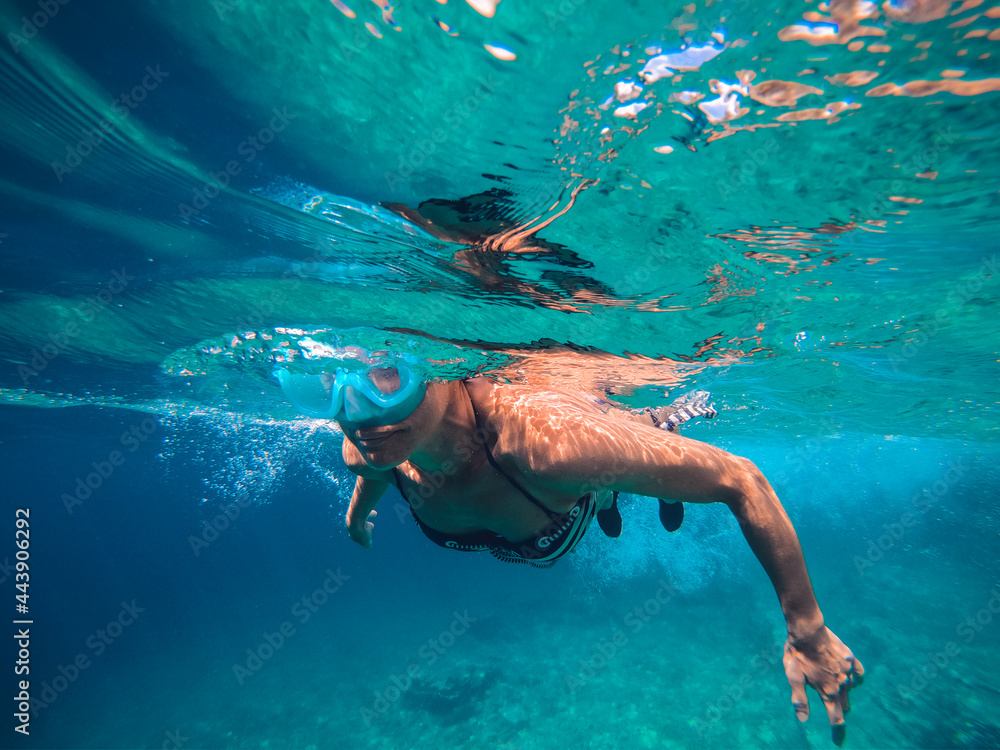 Woman snorkeling in the shallow sea water
