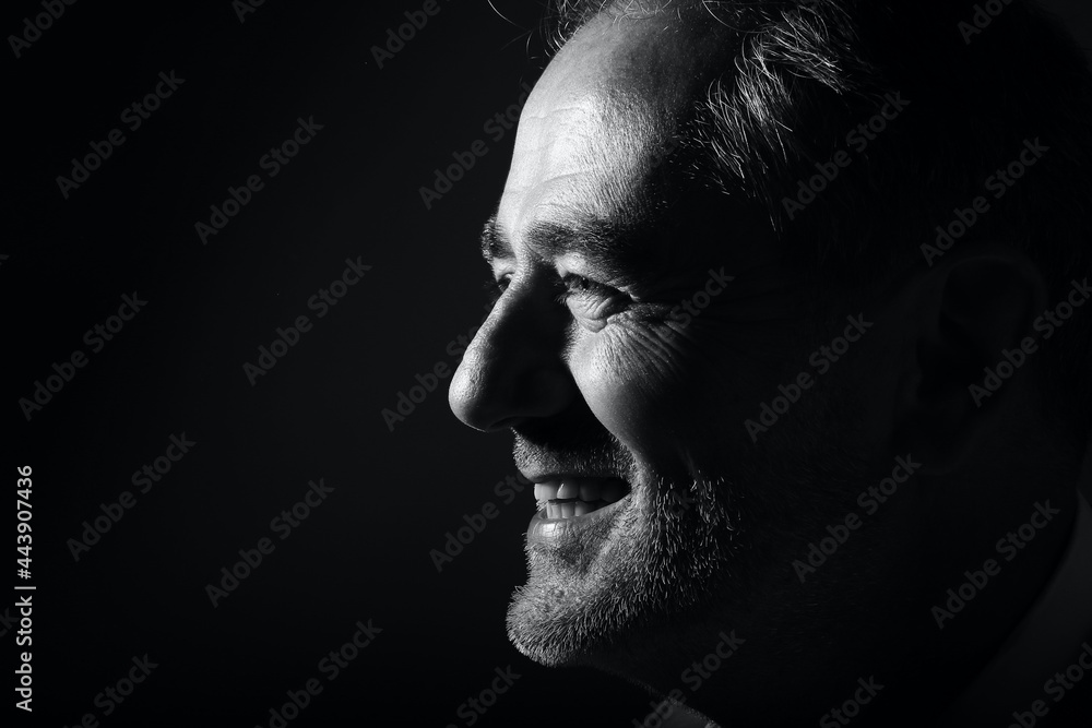 Beautiful black and white portrait from a man in front of a background Beautiful black and white portrait from a man in front of a background
