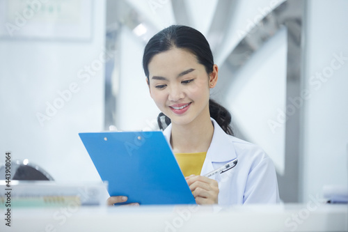 Portrait of young beauty doctor posing alone plastic surgeon's satisfied with positive feedback from her customers and smiling happily