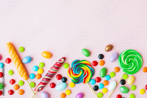 Colorful candies on a pink background
