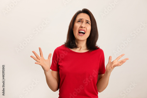 Wallpaper Mural Portrait of screaming woman filled with hate on light background Torontodigital.ca