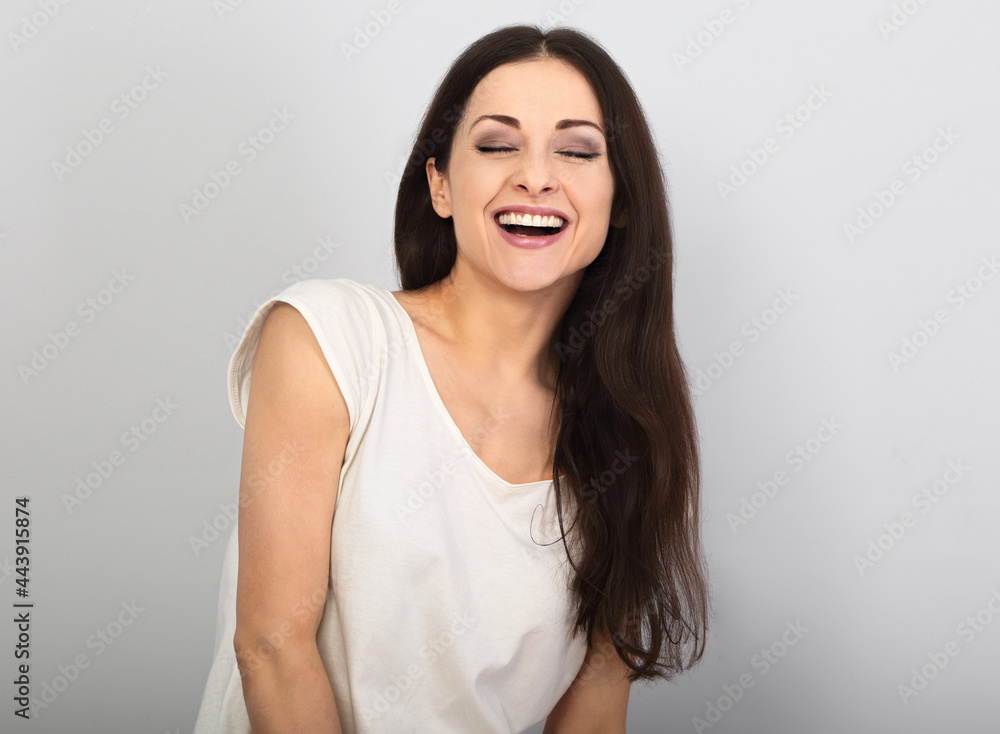 Happy loudly laughing woman with happy smile on blue background. Happy loudly laughing woman with happy smile on blue background.