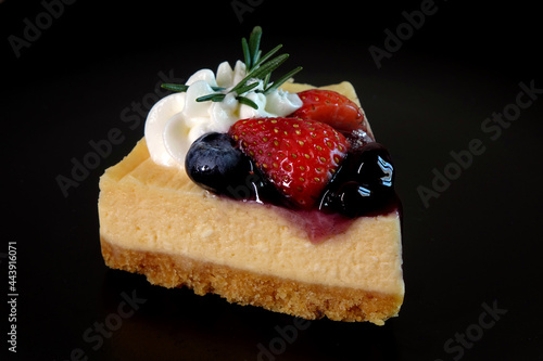 Fototapeta Naklejka Na Ścianę i Meble -  Strawberry and Blueberry French cheese cake. Cheese cake isolated on black background.
