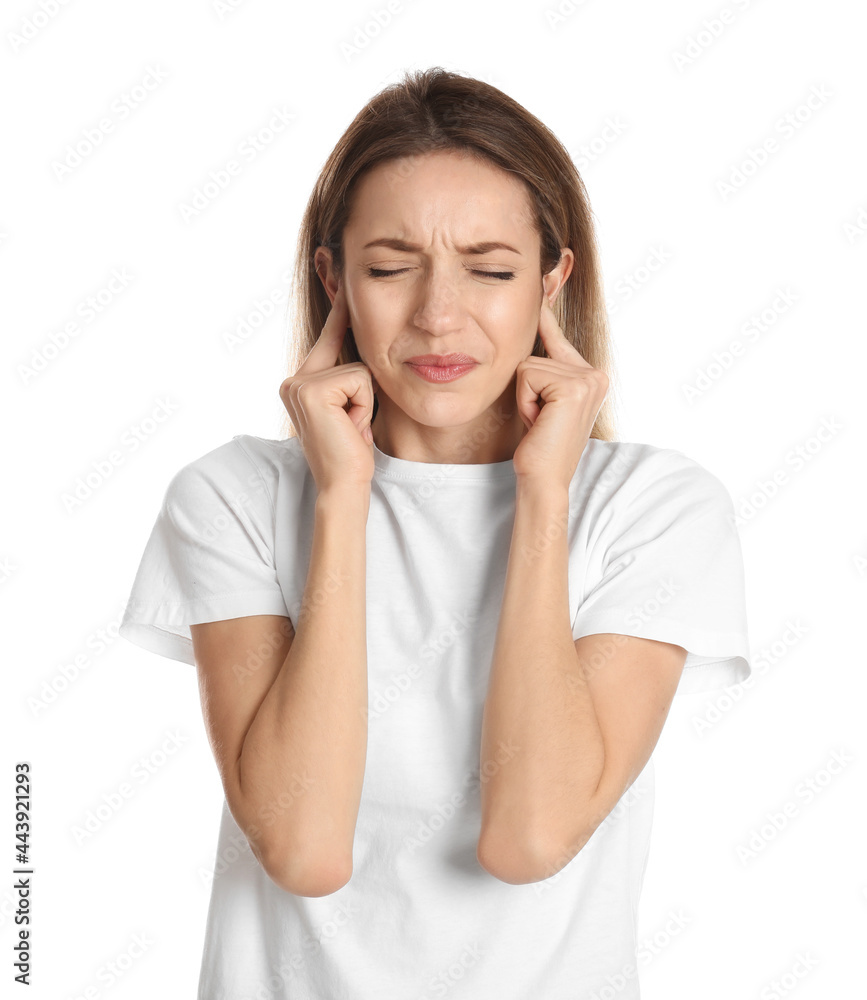 Emotional young woman covering her ears with fingers on white background Emotional young woman covering her ears with fingers on white background