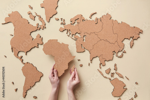 Woman putting African continent on map
