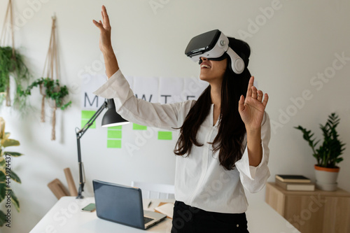 Young woman using virtual reality glasses photo