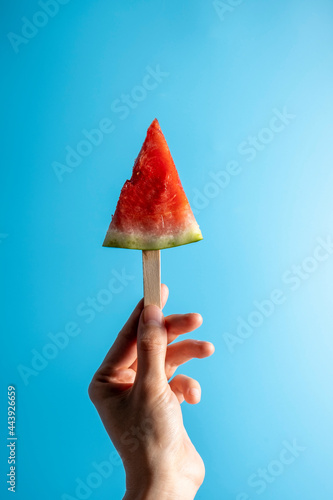 watermelon on woman s hand on blue background