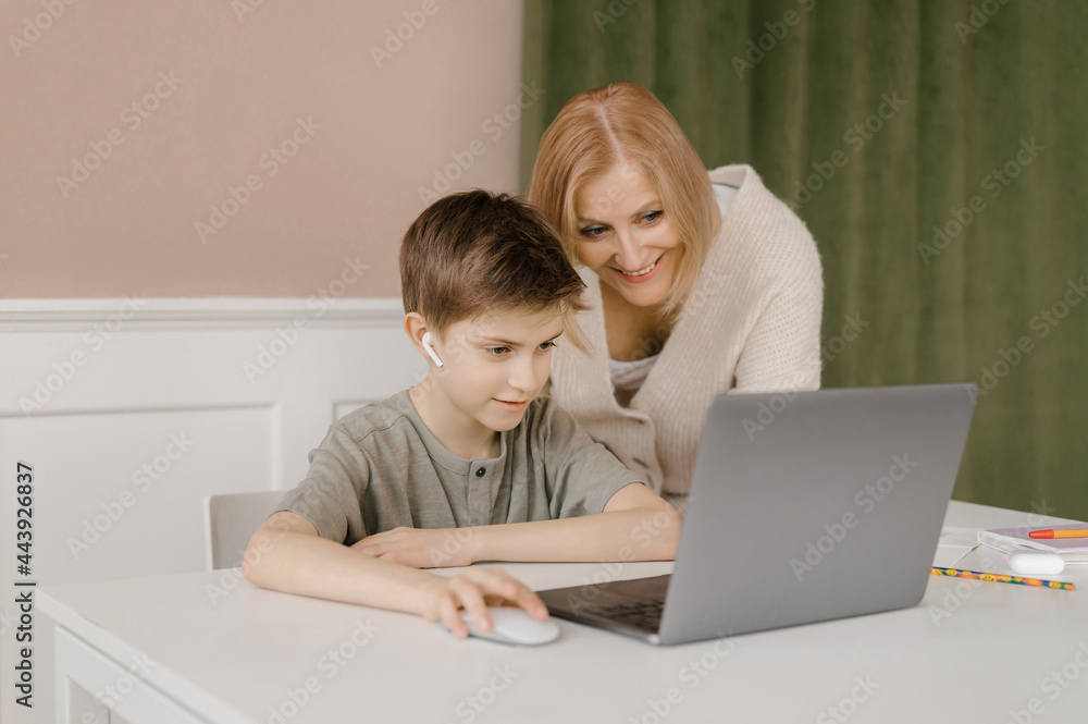 Loving mother helping son with homework Loving mother helping son with homework