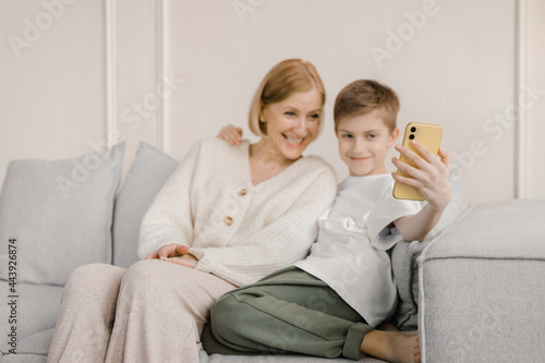 Content mother and son taking self shot on smartphone photo