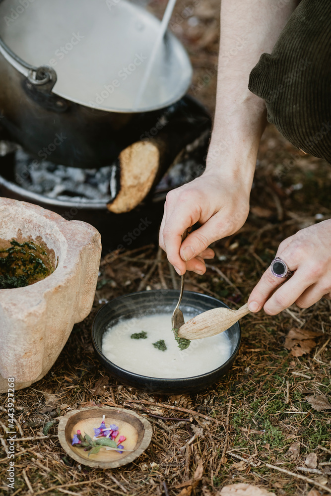 Young Man Garnishing Soup In The Wood Young Man Garnishing Soup In The Wood